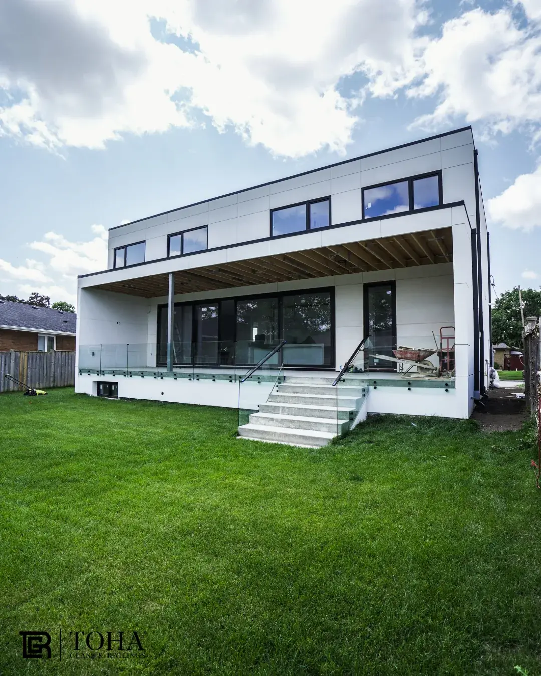 Frameless glass railings on a rear deck and stair